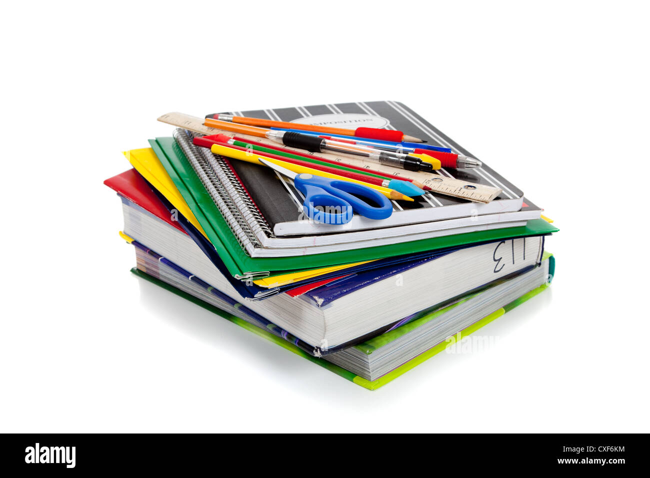 stack of school books and supplies on a white background cxf6km